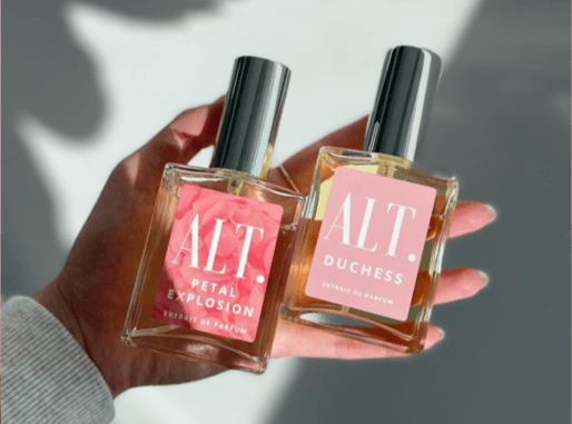 Hand holding ALT Fragrances perfume bottles